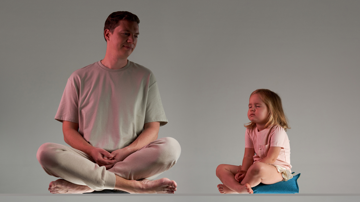 Father and daughter meditating together on SUMA Fold and Manta cushions
